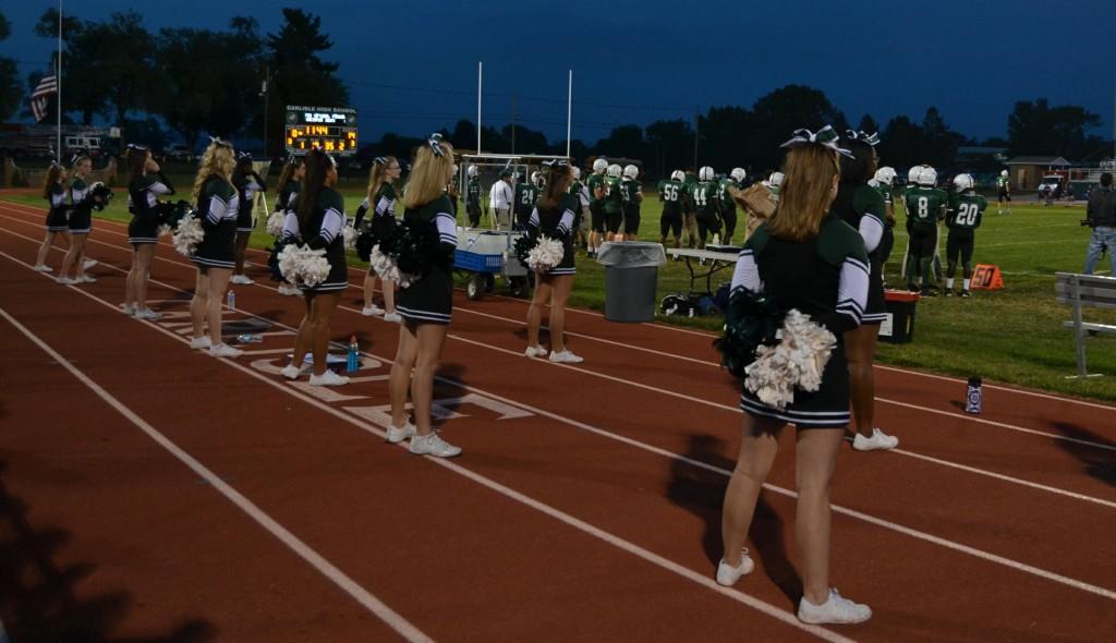Cheerleaders+wear+their+green%2C+white%2C+and+black+uniforms%3B+for+school+days+they+must+add+black+leggings+to+be+considered+school+appropriate.