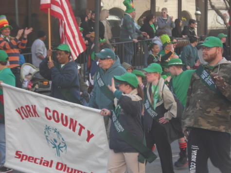 Some special kids and adults wave to the crowd and smile happily as they pass each and every one of us. 