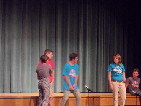 Junior Karina Ciocca, seniors Ellis Johnson, Griffin Mann, and Jess Smith acting silly on stage, entertaining the audience with their sarcastic and funny personalities. 