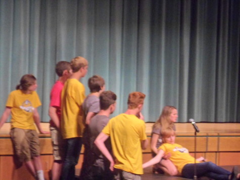 Sophomores Victoria Liebetrau and Alexis Van Meter lay/sit on the stage during one of the games; the audience was amused a lot while these two played the game. 