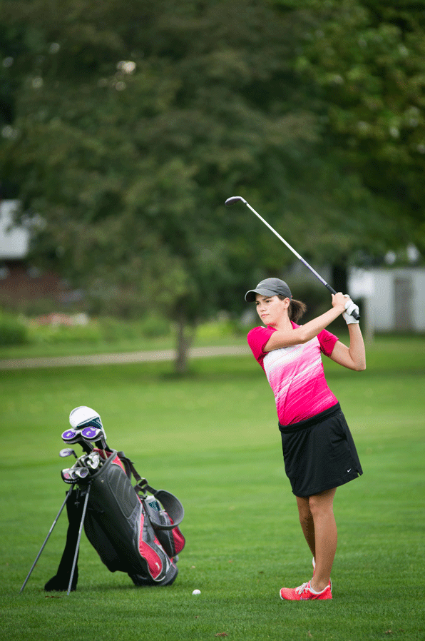 Andee Orsini takes a practice swing at the ball during one of her matches. Orisini is one of five girls on the team this year.