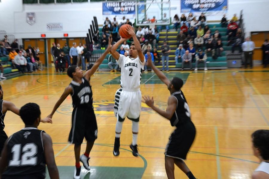 Deonte Ramsey takes a jump shot against Harrisburg on Tues Jan 16.  Boys basketball is heading to playoffs, with a 14-6 record.