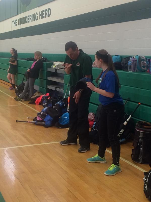 Coach Eric Behrenshausen helps a softball player during an open gym on Tuesday.  