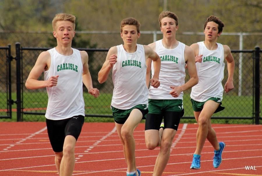 Junior Matt Wisner, sophomore Isaac Kole, senior Ben Hietsch and sophomore Max Fiorentino run a 800m race during a track meet.