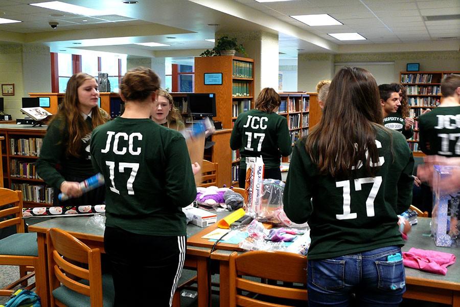 Members of Junior Class Council wrap presents.