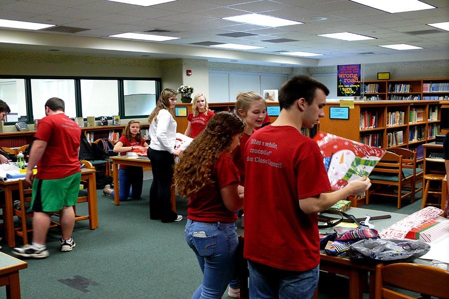 The Senior Class Council helps to wrap presents for Adopt a Family.