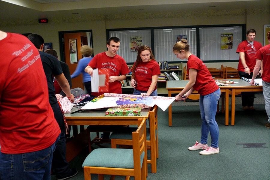 The Senior Class Council prepares Adopt a Family gifts.