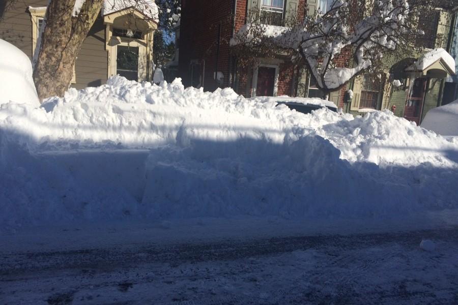 If you look closely there is a car totally covered with plowed snow Sunday morning.