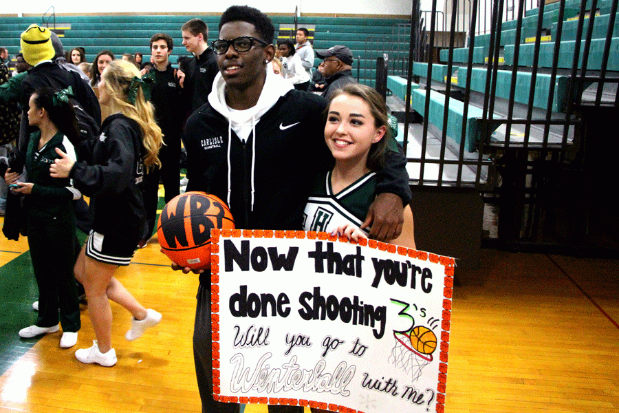 CHS seniors Jordan Purcell and Nicole Wellmon pose after a successful Winter Ball proposal.  Wellmon surprised Purcell at the end of his basketball game.