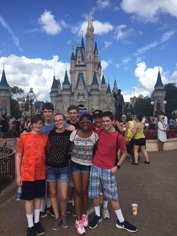 Marching Band members (left to right) Aidan Piper, Cameron Fritz, Carol Itzel, Ben Adelberg, Chaela Williams, Dan Lewis, and Reece Bower pose in front of the Magic Kingdom  at Disney World. The band recently traveled to Orlando from Dec 26-Dec 31.