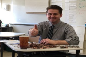 Mr. Erb counts change during Mini-THON club's annual Stall Day. The fundraiser raised $940 for the Four Diamonds Fund.
