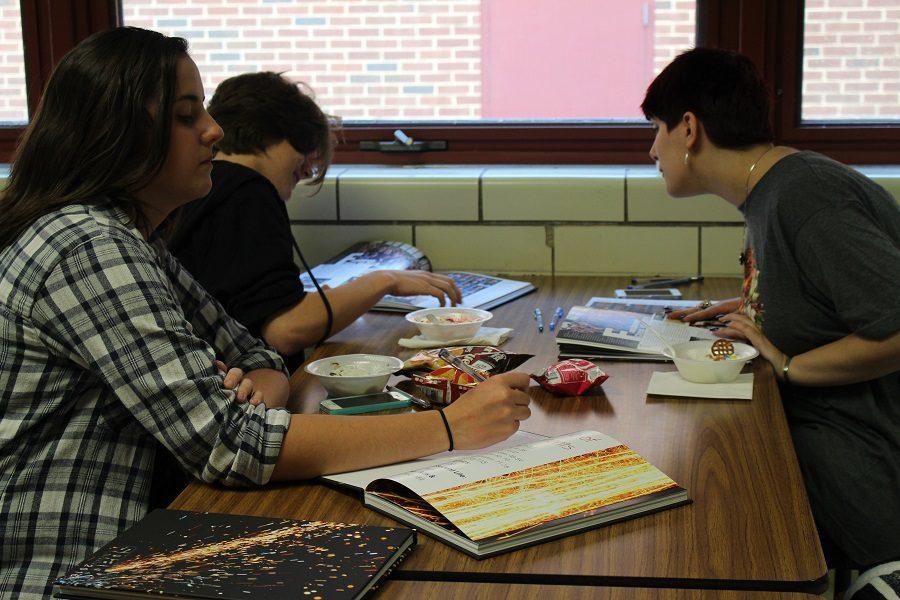Junior Rowan Young signs her friend's yearbook.