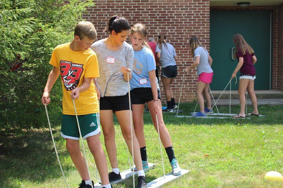 Students communicate and work together to navigate their "car" on the "highway."