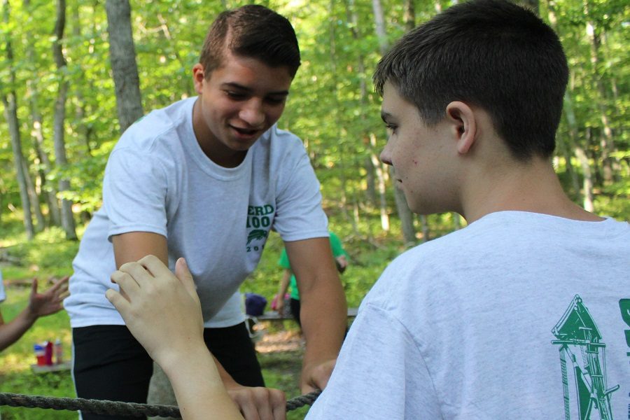 While being carefully spotted team members worked their way through the low ropes course.