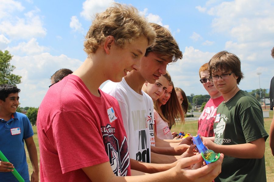 Casey Padgett, Shane Golden, and Wyatt Morrison work together with their other team mates to get the "oil" safely through the "pipes."