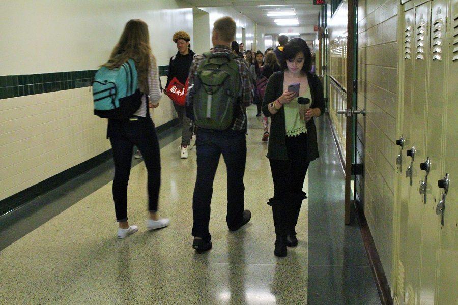 Senior Sami Jumper faux-texts while walking through the halls.
