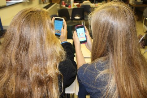 Two CHS students explore the new app Sit with Us. This app could change the way students feel about the awkward social situation of sitting in the cafeteria.