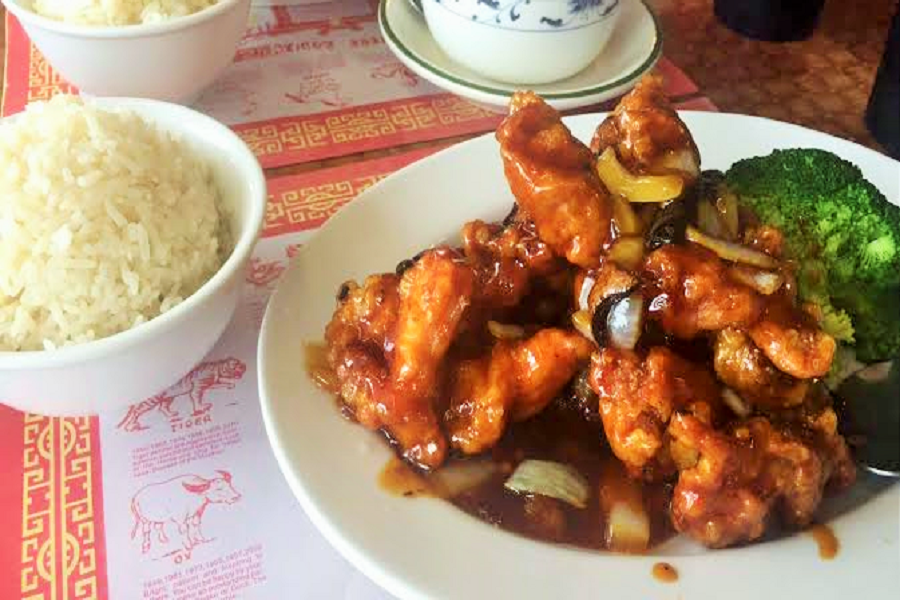 The orange chicken on the menu was served in a scrumptious sauce with a side of white rice.