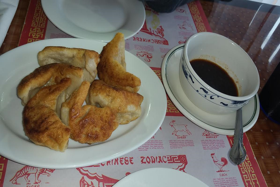 This tasty appetizer, fried dumplings, was served with a delicious dipping sauce.
