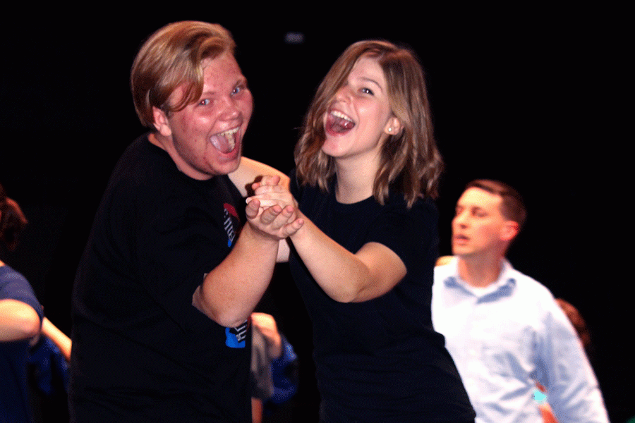 Senior Ellen Diehl and Junior Ozzy Smith laugh as they practice their royal dance for the CHS production of Cinderella as director Dan Schade looks on.