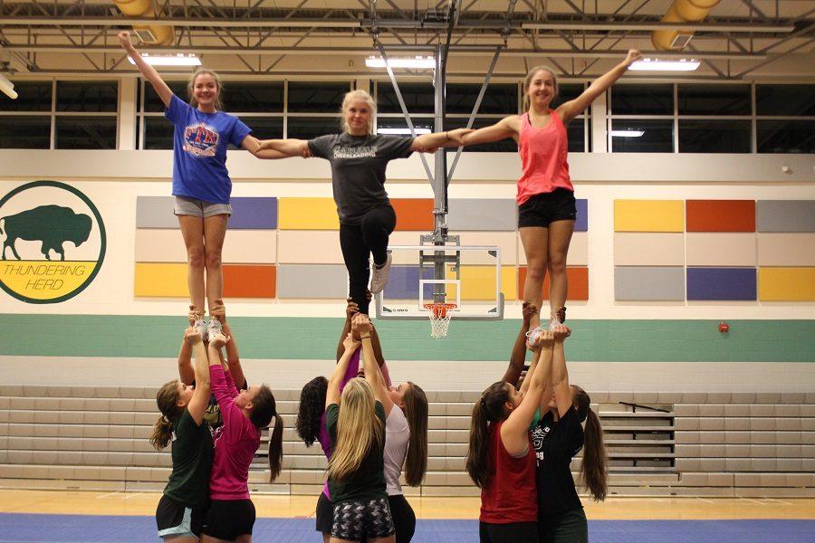 The CHS Varsity cheerleading squad performs a stunt at their practice.