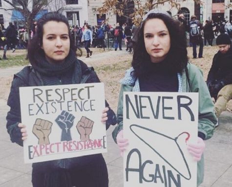 Katherine Stockton-Juarez, right. and her sister Cristina hold signs at the Women's March on Washington.