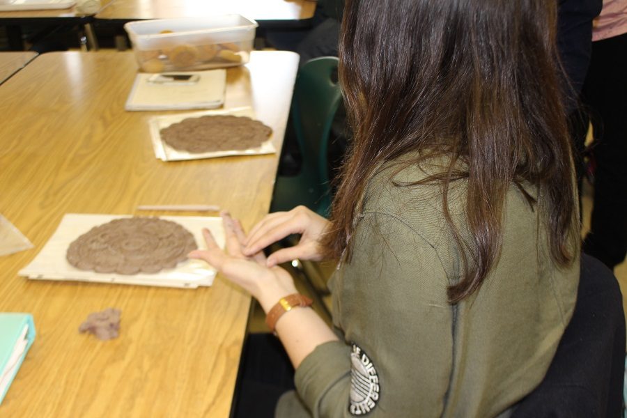 Art Service Club making clay bowls for Empty Bowls.