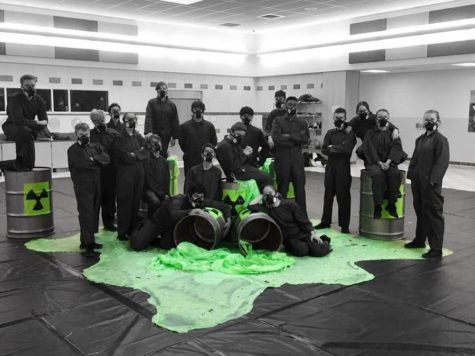 Members of indoor percussion pose with their toxic waste props in the Wilson Middle School cafeteria, where they practice. 