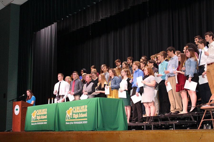 Inductees after being made members of NHS.  Members held candles representing themselves uniting to make a difference in their community.  