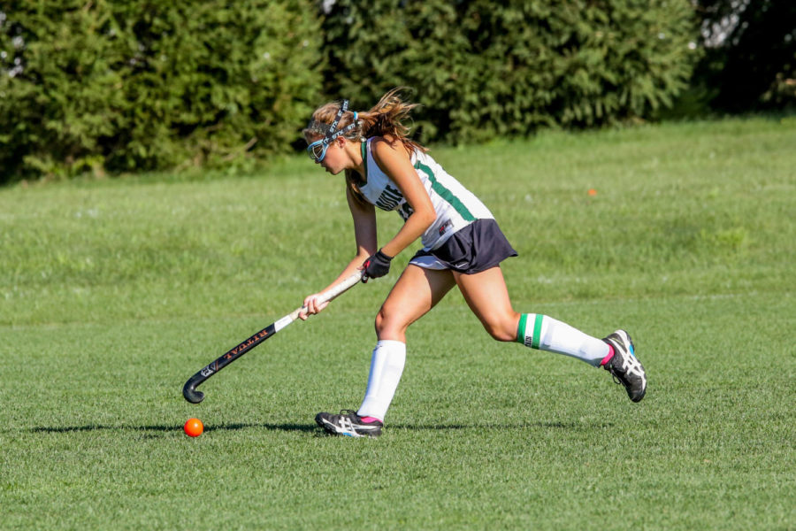 2016-2017 senior field hockey co-captain Lizzy Neslund shows off her skills. Field hockey team members train all summer for the fall season.