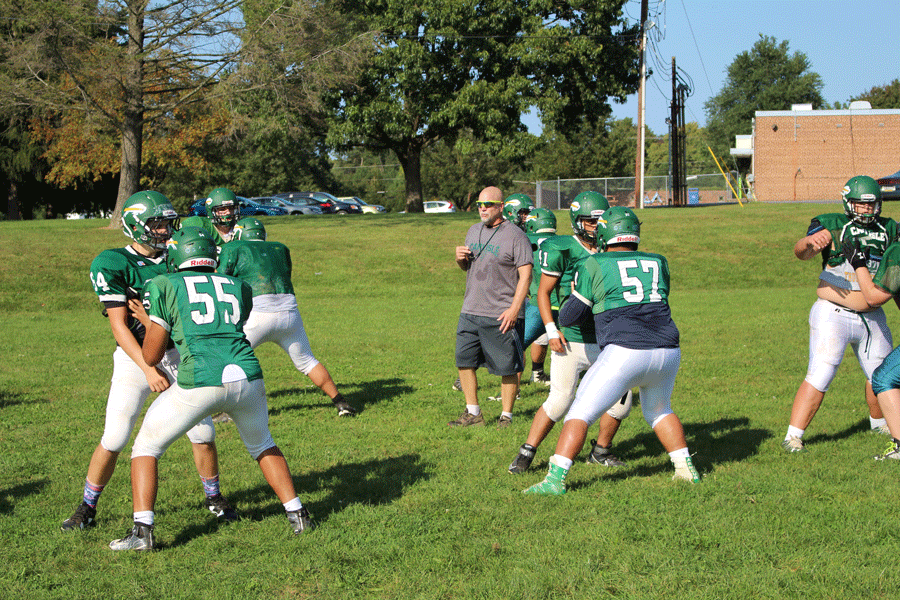 Coach Brian Warner leads a drill at practice.  He is one of the new coaches this season.