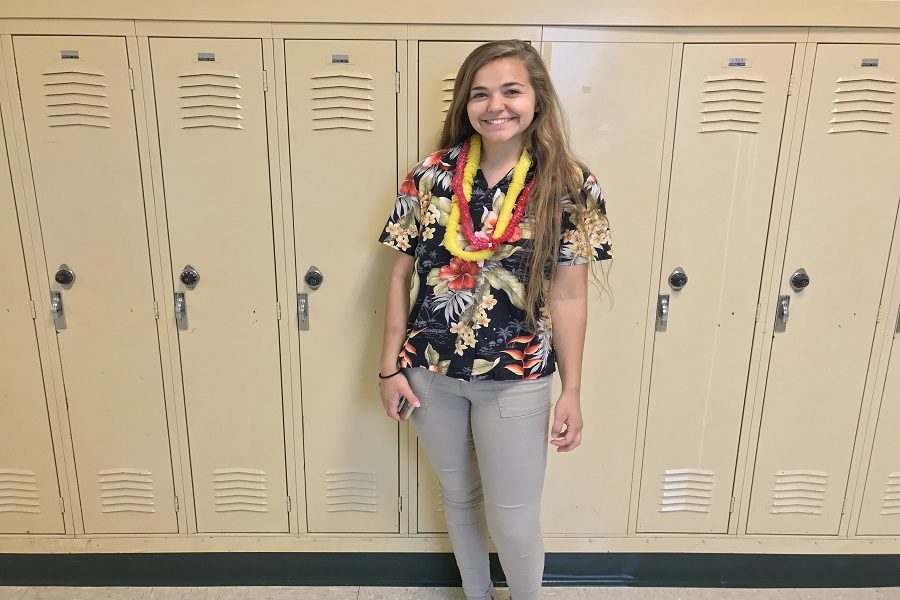 Senior Josie Carlton poses in her tropical outfit. Carlton said, It’s an easy and fun way to get student points for the different grade levels.