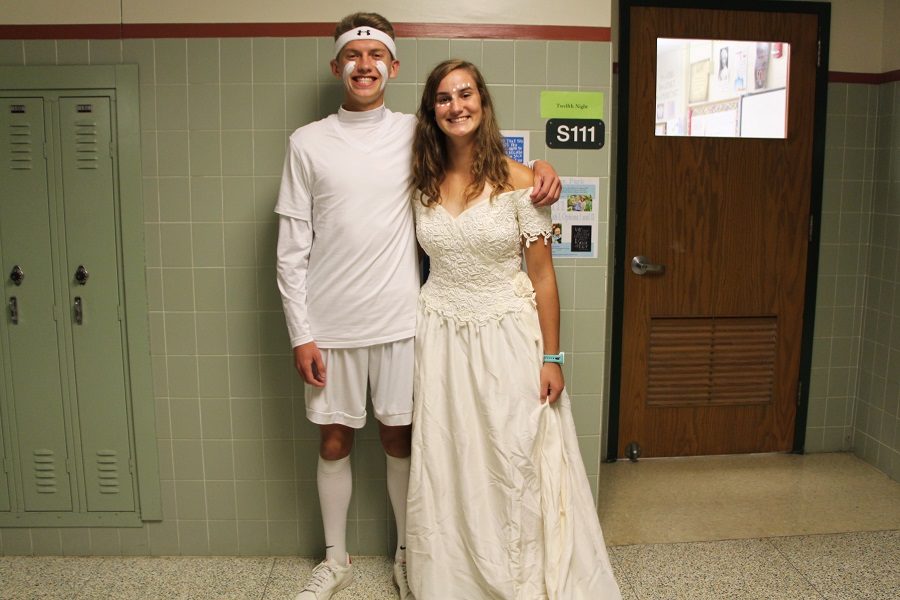 Seniors Emilie Zukowski and Ely Brode show off their class color, white. Zukowski was keeping the tradition of a senior girl wearing a wedding dress alive.