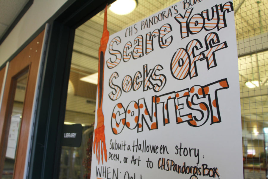 A poster for Pandoras Boxs Scare Your Socks Off competition. The student-run literary magazine runs several holiday related submission contests throughout the year.