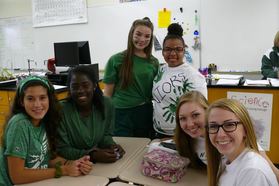 Juniors and seniors work together in classes. Though everyone battles to be the best class during the day, everyone comes together for a white-out for the Homecoming football game.