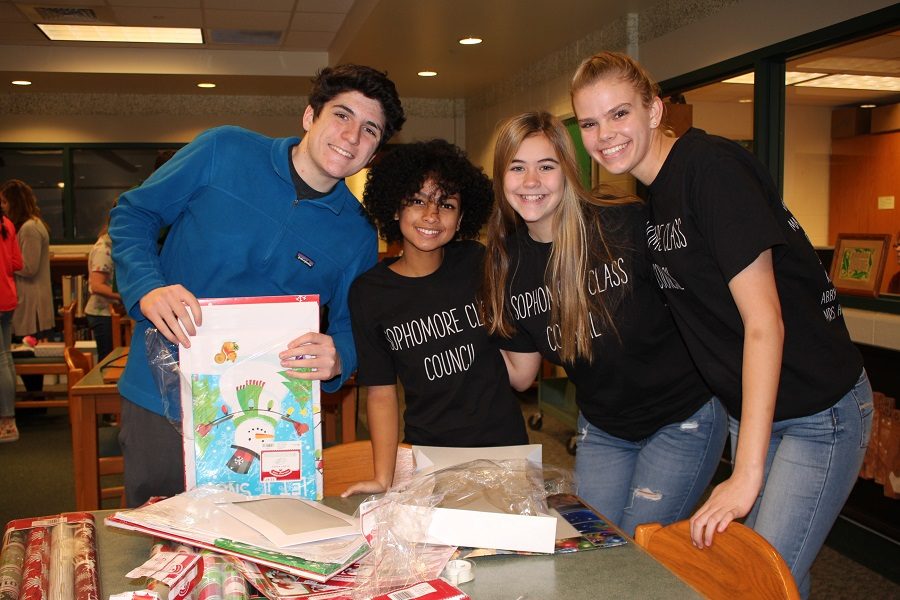 Sophomores James Echevarria, Taytum Robinson-Covert, Ilyra Carlton, and Holly Stiltner pose with presents they wrapped for Adopt a Family. The Adopt a Family program bought and wrapped presents for four families this year.