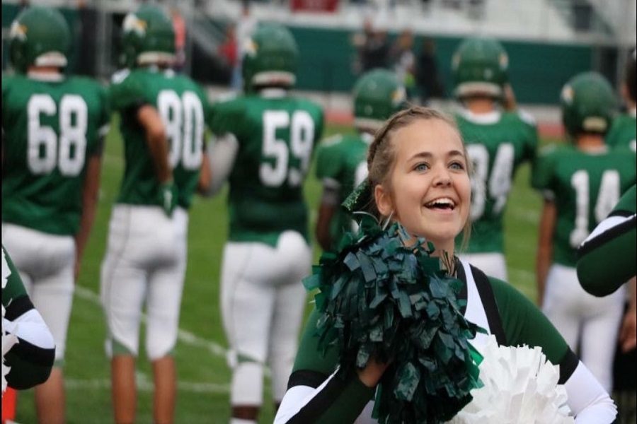 Josie Carlton cheers loudly at a home game after a good play.  This is Carlton's third year on the squad,this year as co-captain. 