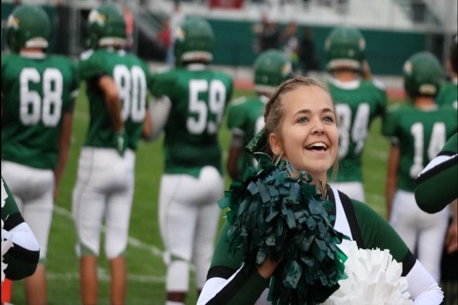 Josie Carlton cheers loudly at a home game after a good play.  This is Carltons third year on the squad,this year as co-captain. 