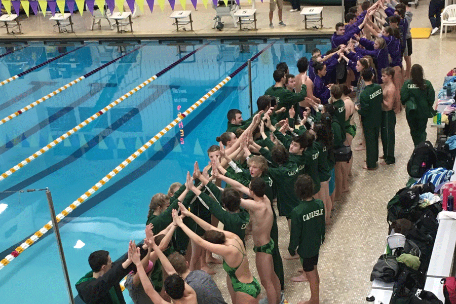 Swimmers from Carlisle and Boiling Springs create a human tunnel for senior night.  Carlisle split this meet with a boys win and girls loss.
