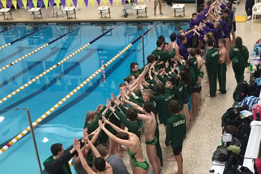 Swimmers from Carlisle and Boiling Springs create a human tunnel for senior night. Carlisle split this meet with a boys win and girls loss.
