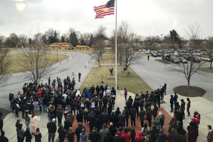 Students stand around the flagpole during the walkout. The walkout paid tribute to the victims of the Parkland shooting, and included several speakers on the issue of gun control.