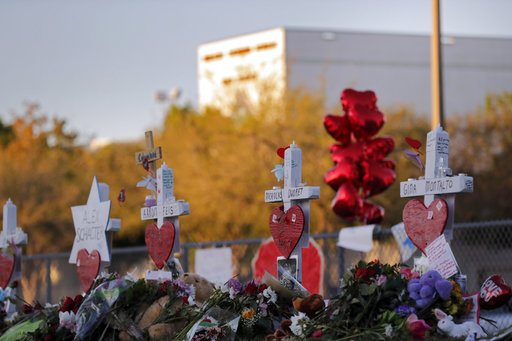 This Feb. 19, 2018 file photo shows a makeshift memorial outside Marjory Stoneman Douglas High School, where 17 students and faculty were killed in a mass shooting in Parkland, Fla. Parkland city’s historian Jeff Schwartz is setting a plan in motion to collect, archive and preserve the Marjory Stoneman Douglas mementos. Meanwhile, school administrators have vowed to build a memorial after the demolition of the building where the Feb. 14 attack took place. (AP Photo/Gerald Herbert, File)