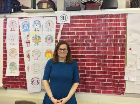 English teacher Sarah Clayville stands in front of one of her Harry Potter themed walls. 