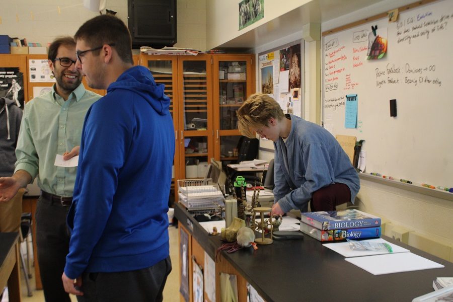Matthew Prestgaard goes over lesson plans while Biology teacher Jimmy Wilkinson helps students. Prestgaard has been helping Wilkinson teach AP Biology.