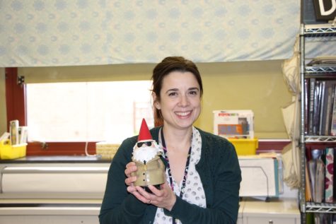 Rachel Drumheller poses with one the many gnomes around her classroom. 