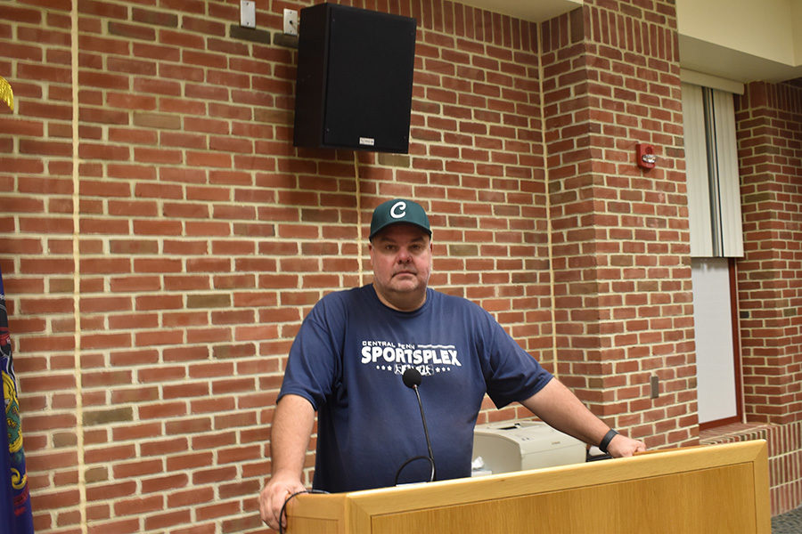 Coach Sullenberger stands at the podium ready to begin the pre-season meeting.  Sullenberger is the newly appointed coach for the upcoming 2019 spring season. 