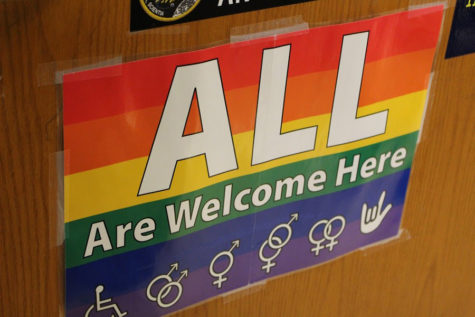 A poster on Rachel Hull's classroom door reads "All are welcome here." Hull is the adviser for the SAGA  club, and the message is one the organization has taken on as part of its mission.