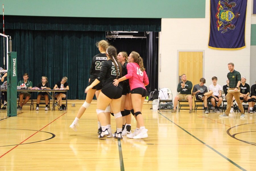 The girls celebrate after successfully scoring a point.  The team scored the most points in the first match.