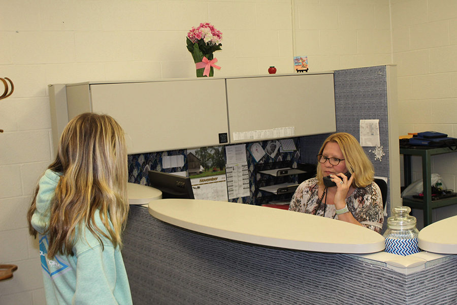 A student talks to Mrs. Sue Yingling, the Secretary to the Director of IT operations 