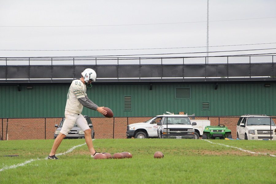 Caleb Richwine prepares to punt the ball at footbal practice.  Richwine raised money throughout the past two seasons for kids with cancer.  